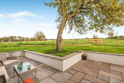 a patio with a tree in a field at 3 Bed in Wigton oc-f33746 in Westward