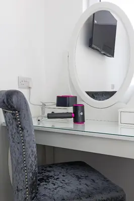 a desk with a mirror and a chair and a mirror at Savoy 5 in Ayr