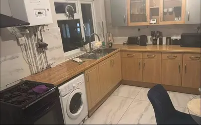 a kitchen with a washer and a stove and a dishwasher at 23 Ash road in Moffat