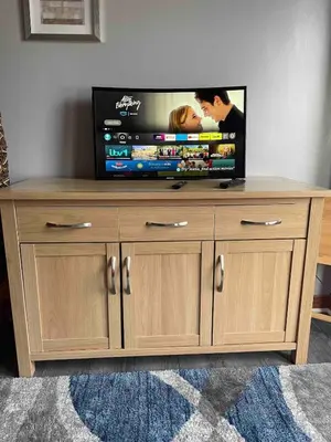 a flat screen tv sitting on top of a wooden entertainment center at Room with a view in Irvine