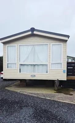 a mobile home is parked in a parking lot at 17 Ruby Atlas Monreith in Monreith