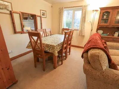 a dining room with a table and chairs and a couch at Thrang View in Ambleside