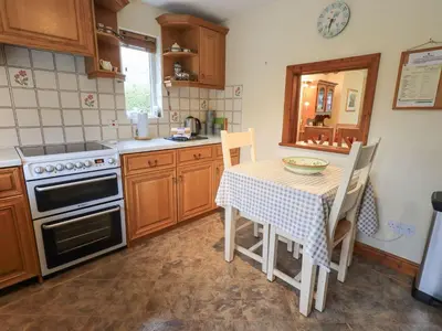 a kitchen with a table and a stove top oven at Thrang View in Ambleside