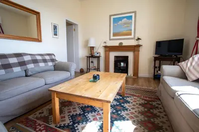 a living room with a couch and a coffee table at Moir Cottage in Portpatrick