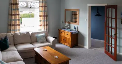a living room with a couch and a table at 2-Bedroom Flat South Ayrshire in Troon