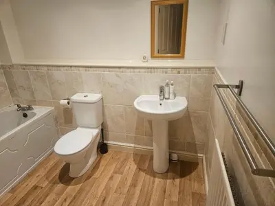 a bathroom with a toilet and a sink at Carlisle Stunning 2 Bed Appt with Parking 5 mins J42 M6 in Carlisle