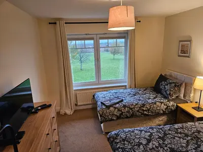 a hotel room with a bed and a window at Carlisle Stunning 2 Bed Appt with Parking 5 mins J42 M6 in Carlisle