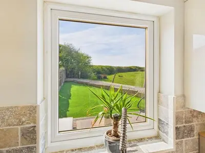 a window in a room with a potted plant at The Haven Holiday Home in Woodend