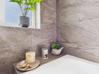 a candle sitting on a counter in a bathroom at The Haven Holiday Home in Woodend