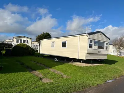 a white tiny house in a yard at MaCEIDEIRD in Mainsriddle