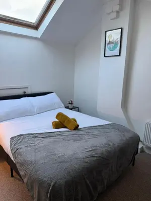 a bedroom with a bed with two towels on it at Cockermouth Cottage - Lakes - Parking in Cockermouth