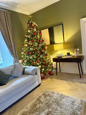 a christmas tree in a living room with a couch at Bankhouse in Troon