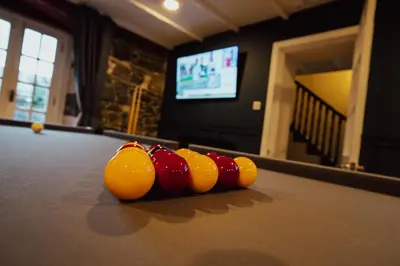 a row of cue balls on a pool table at Bankhouse in Troon