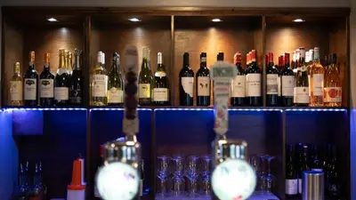 a bunch of bottles of wine sitting on a shelf at The Briery in Workington