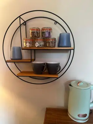 a shelf with jars and bowls on a wall at The Briery in Workington