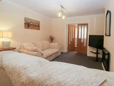 a living room with a bed and a couch at Mables in Wigton