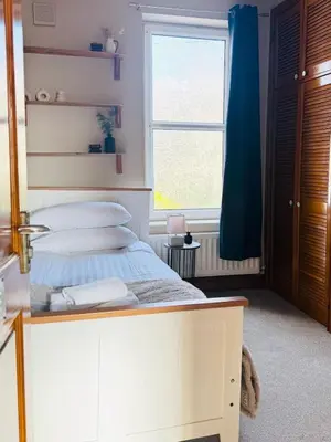 a bedroom with a bed and a window at Central Carlisle Modern 4BD w Wi-Fi, Washer, & SmartTVs, close to M6 in Carlisle