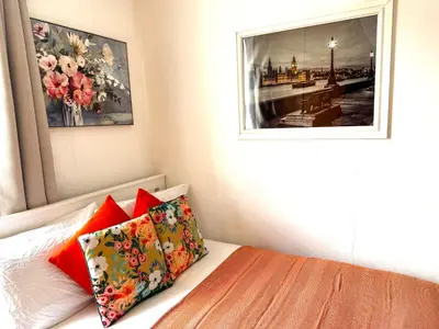 a bed with two pillows and a picture on the wall at Entire 1 bedroom in VAUXHALL Central London Zone 1 in Moffat