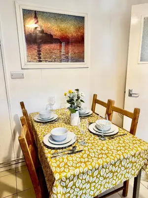 a dining room table with chairs and a painting at Entire 1 bedroom in VAUXHALL Central London Zone 1 in Moffat