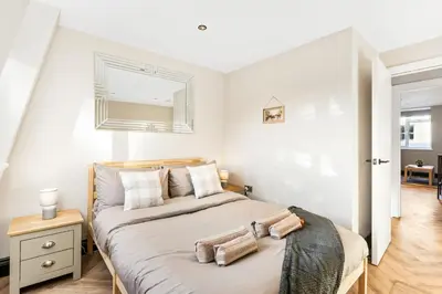 a bedroom with a large bed with two pillows on it at Newly Renovated 1BR Steps from Hove Beach in Moffat
