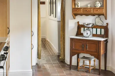 a hallway with a table and a chair in a room at Seaside ParkView Near Lake District and Marina - Pass the Keys in Whitehaven