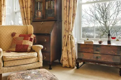 a room with a chair and a dresser and a window at Seaside ParkView Near Lake District and Marina - Pass the Keys in Whitehaven