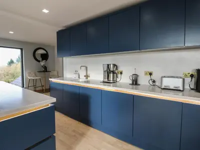 a kitchen with blue cabinets and a counter top at Chapel Hill in Carlisle