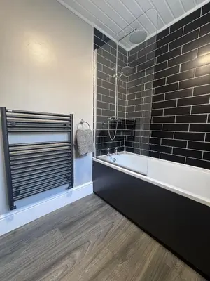 a bathroom with a bath tub and a window at Central Near Hospital 2 Bedroom - Sleeps 4 - Self Check In - Fully Furnished in Carlisle