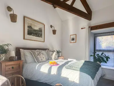a bedroom with a bed with a tray of fruit on it at Lime Tree Barn in Tallentire