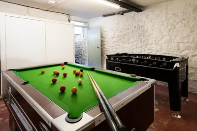 a pool table with balls on it in a room at Orroland Holiday Cottages in Dundrennan