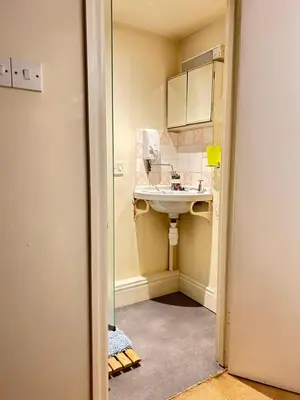 a bathroom with a sink and a mirror at Garden flat at Broomfield in Moffat
