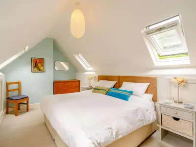 a bedroom with a white bed and a window at 3 Bed in Holmrook oc-sz537 in Beckfoot