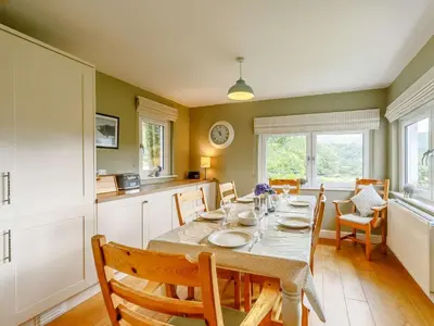 a dining room with a table and chairs in a kitchen at 3 Bed in Holmrook oc-sz537 in Beckfoot