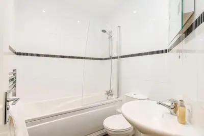 a white bathroom with a toilet and a sink at South Loft a Modern Apartment in Cockermouth in Cockermouth