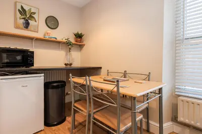 a small kitchen with a table and a microwave at South Loft a Modern Apartment in Cockermouth in Cockermouth