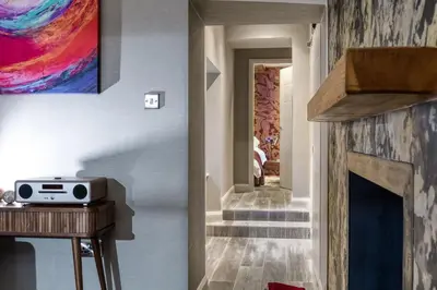 a hallway with a fireplace in a house at Gate Lodge in Castle Douglas