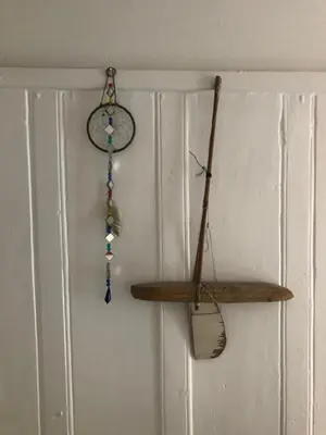 a wall with a clock and a wooden shelf at Romantic Cottage, Port Isaac in Moffat