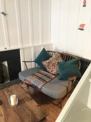 a couch with pillows on it in a living room at Romantic Cottage, Port Isaac in Moffat