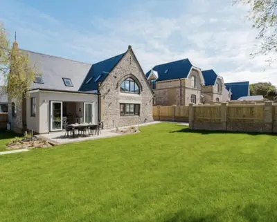 a house with a large yard with a fence at Old School Mews - Shanklin - Dog Friendly in Moffat