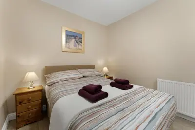 a bedroom with a bed with two towels on it at 1 Harney Peak in Portinscale