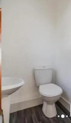 a bathroom with a white toilet and a sink at Pecklewell lodge in Ellenborough