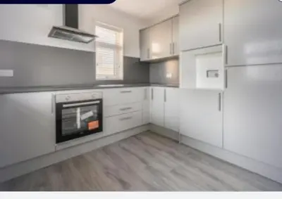 a kitchen with white cabinets and a stove at Pecklewell lodge in Ellenborough