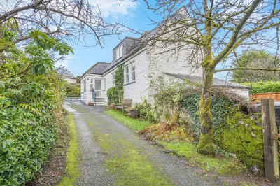 a cottage with a path leading up to a house at 3 Bed in New Galloway oc-r34387 in New Galloway