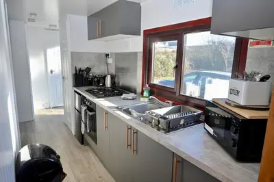 a kitchen with a sink and a stove and a window at Lodge Cabin with Fabulous Views 2 - Farm Stay in Portpatrick