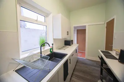 a kitchen with a sink and a window at The Woodrouffee retreat in Carlisle