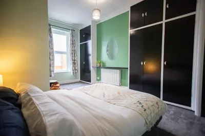 a bedroom with a large bed and a window at The Woodrouffee retreat in Carlisle