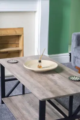 a wooden table with a plate on top of it at The Woodrouffee retreat in Carlisle