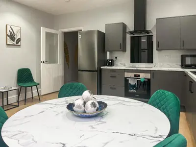 a kitchen with a table with a bowl of balls on it at Lakes And Shores Retreat in Maryport