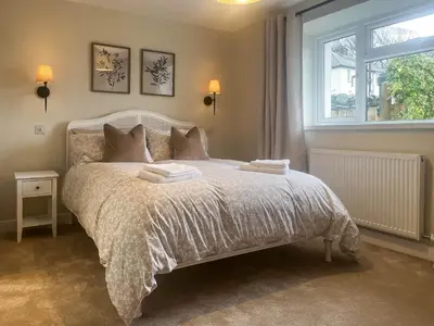 a bedroom with a bed with two towels on it at Garth Cottage in Keswick