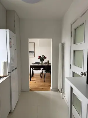 a kitchen with a table and a dining room at Private Rooms Near Acton Main Line Direct Elizabeth Line to Heathrow in Moffat